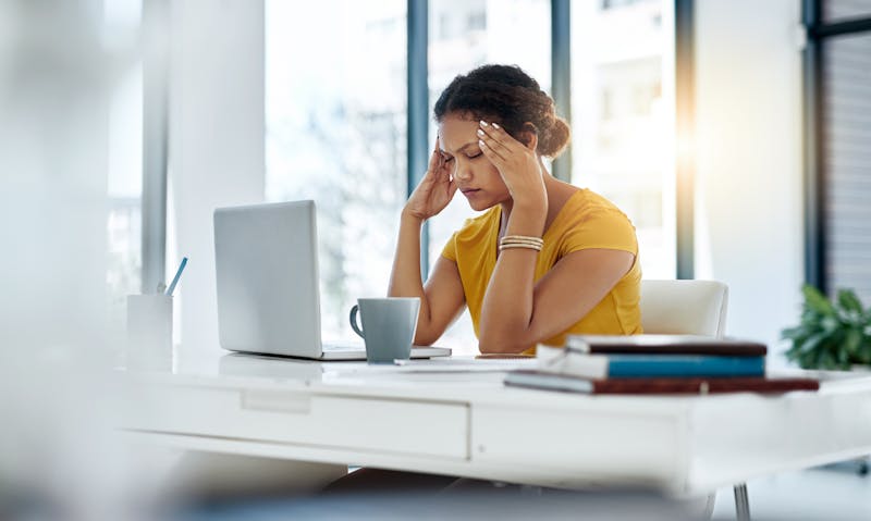 Stressed out business woman in yellow blouse