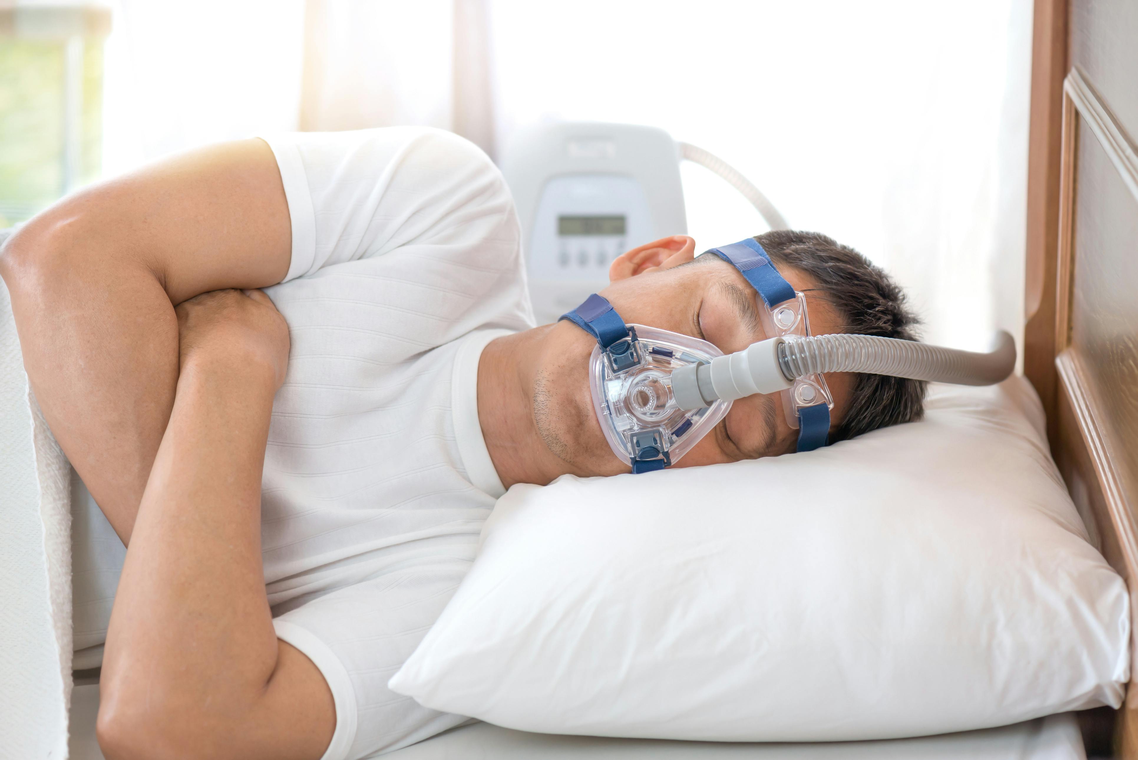 Man sleeping with a CPAP mask on