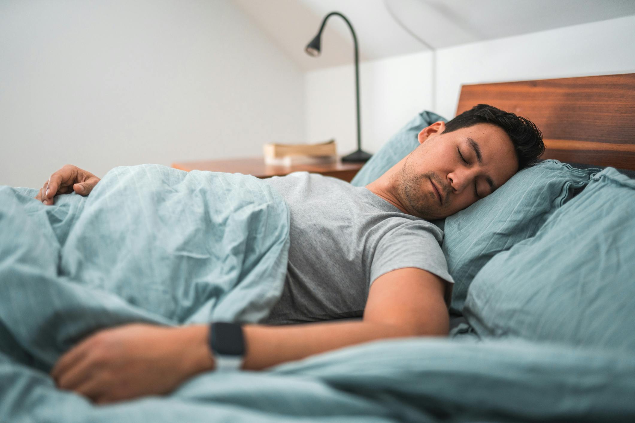 man sleeping on a bed