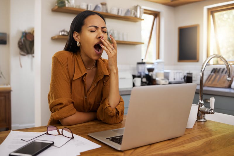 woman yawning while working from home