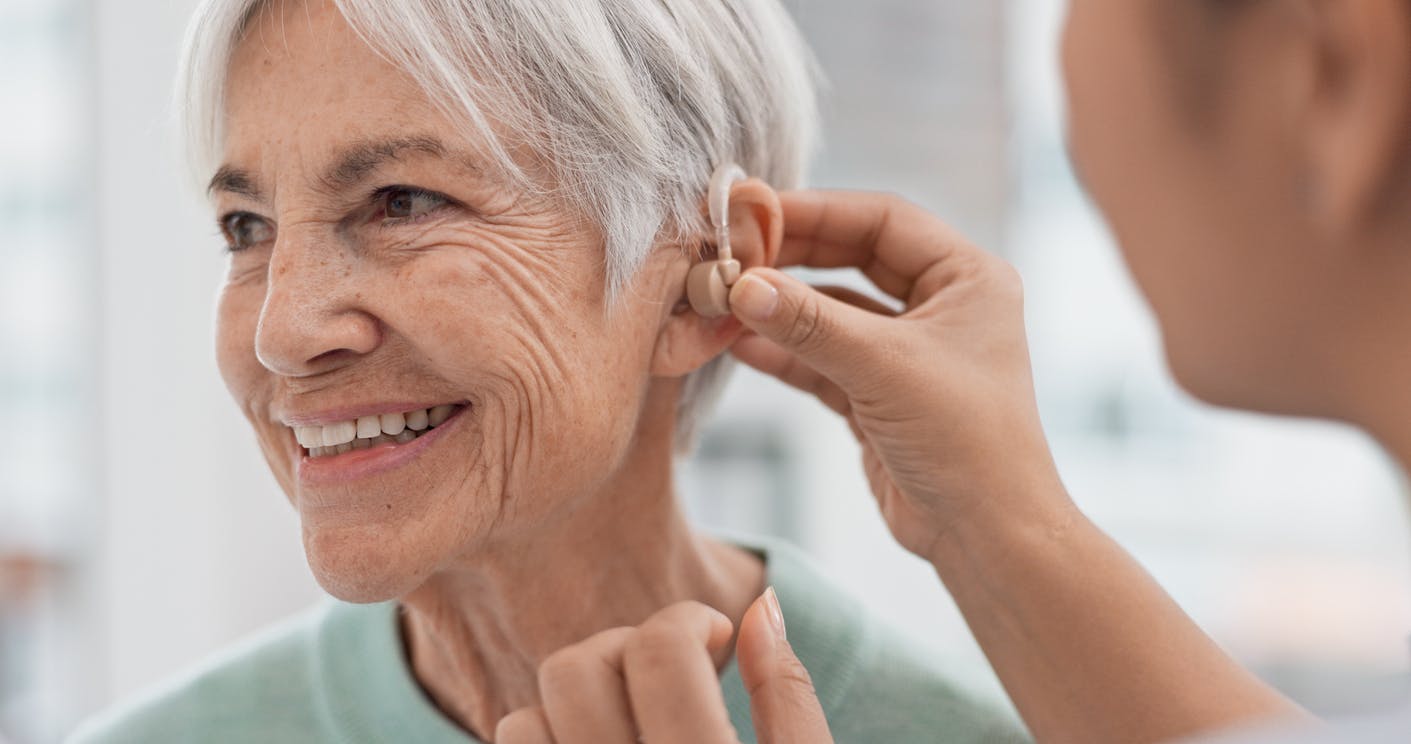 woman getting fitted for hearing aid