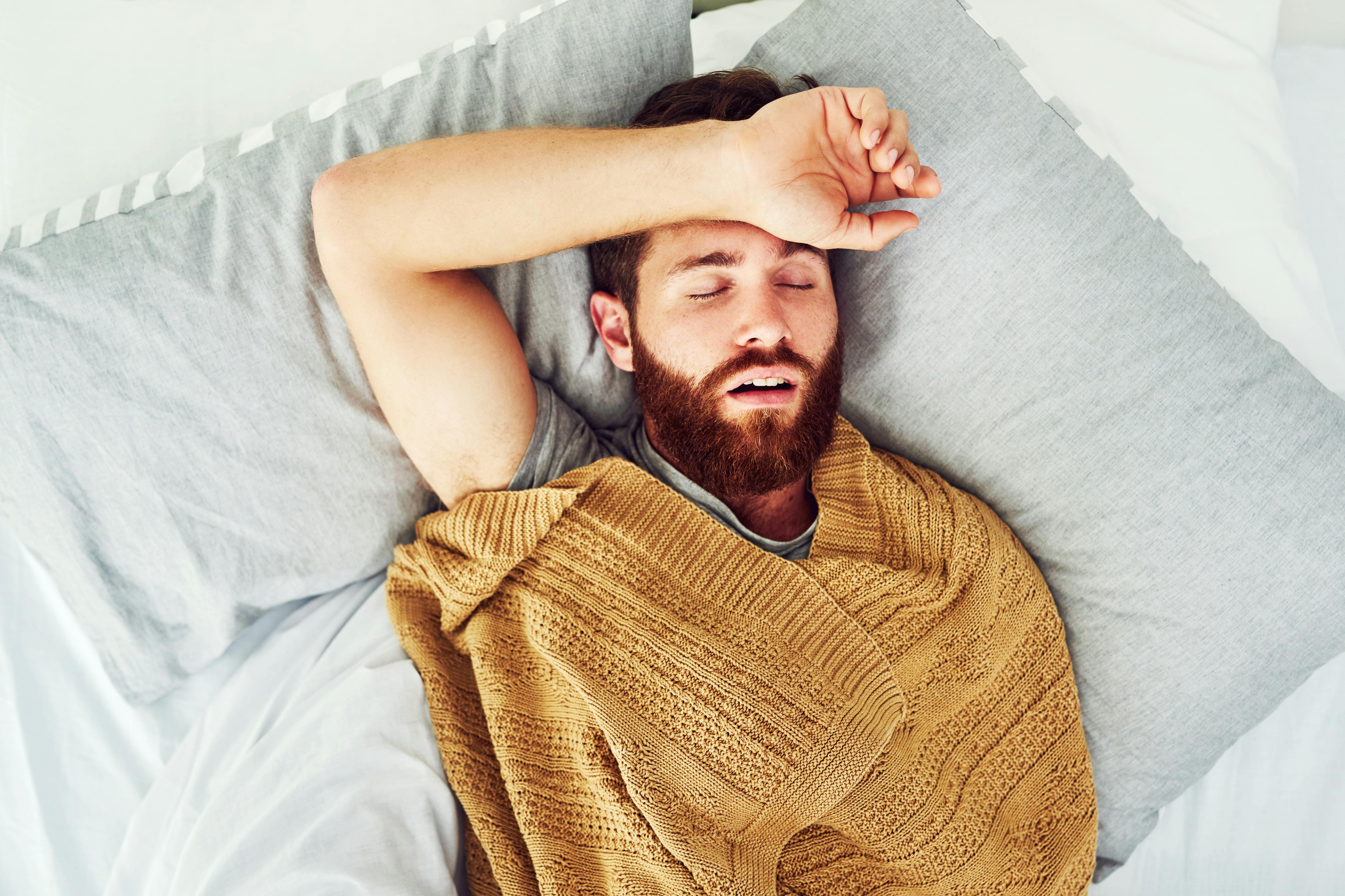 man snoring in bed