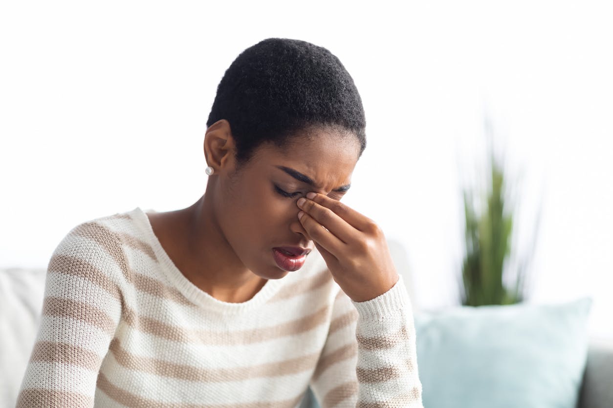 woman holding her sinus