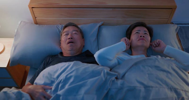 Woman Struggling to Sleep becasue her Husband is Snoring