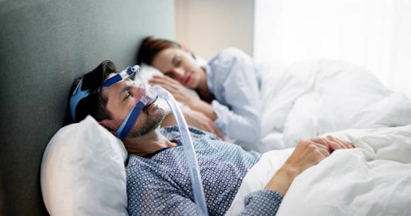Man Asleep with CPAP Machine