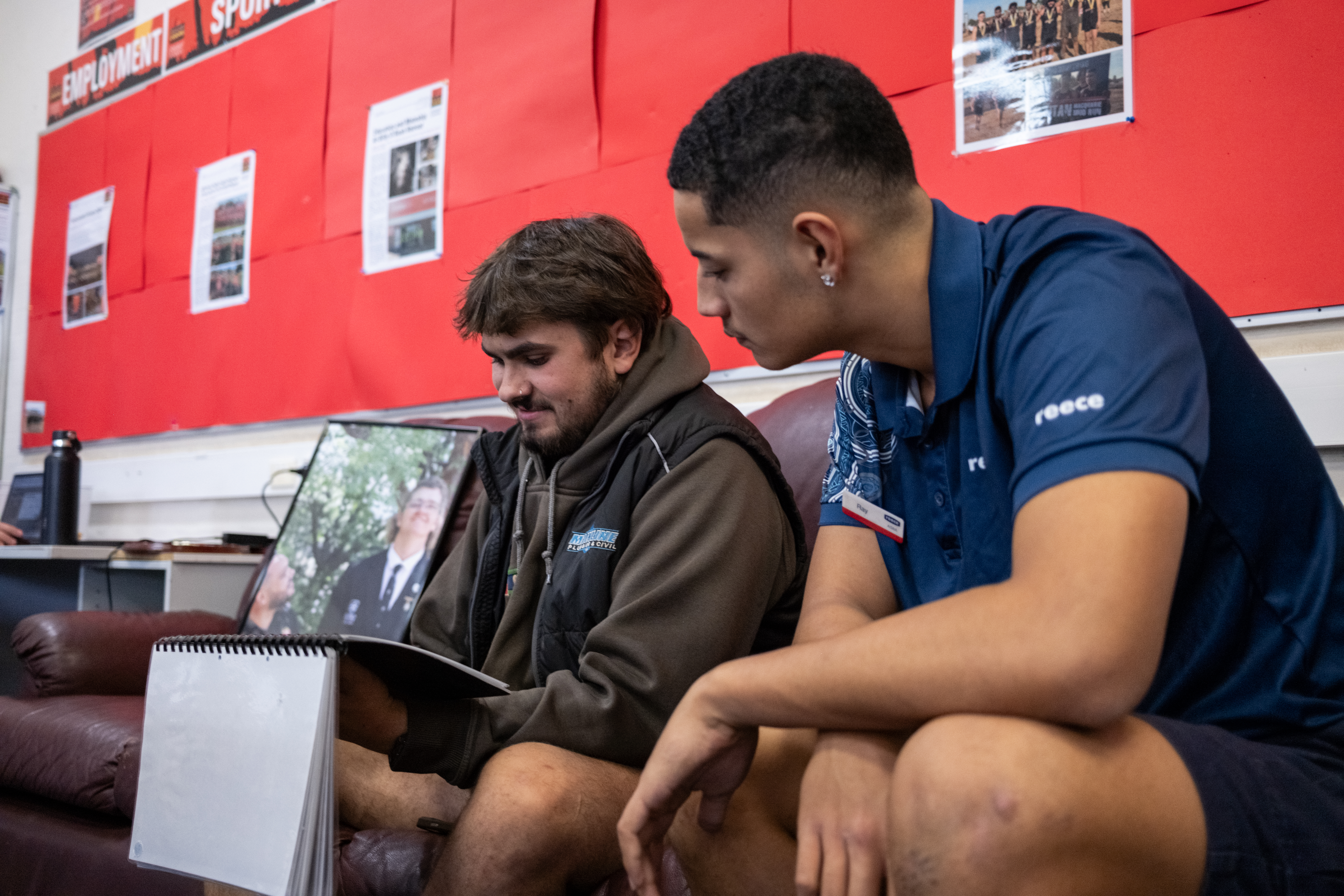 Two men read a book