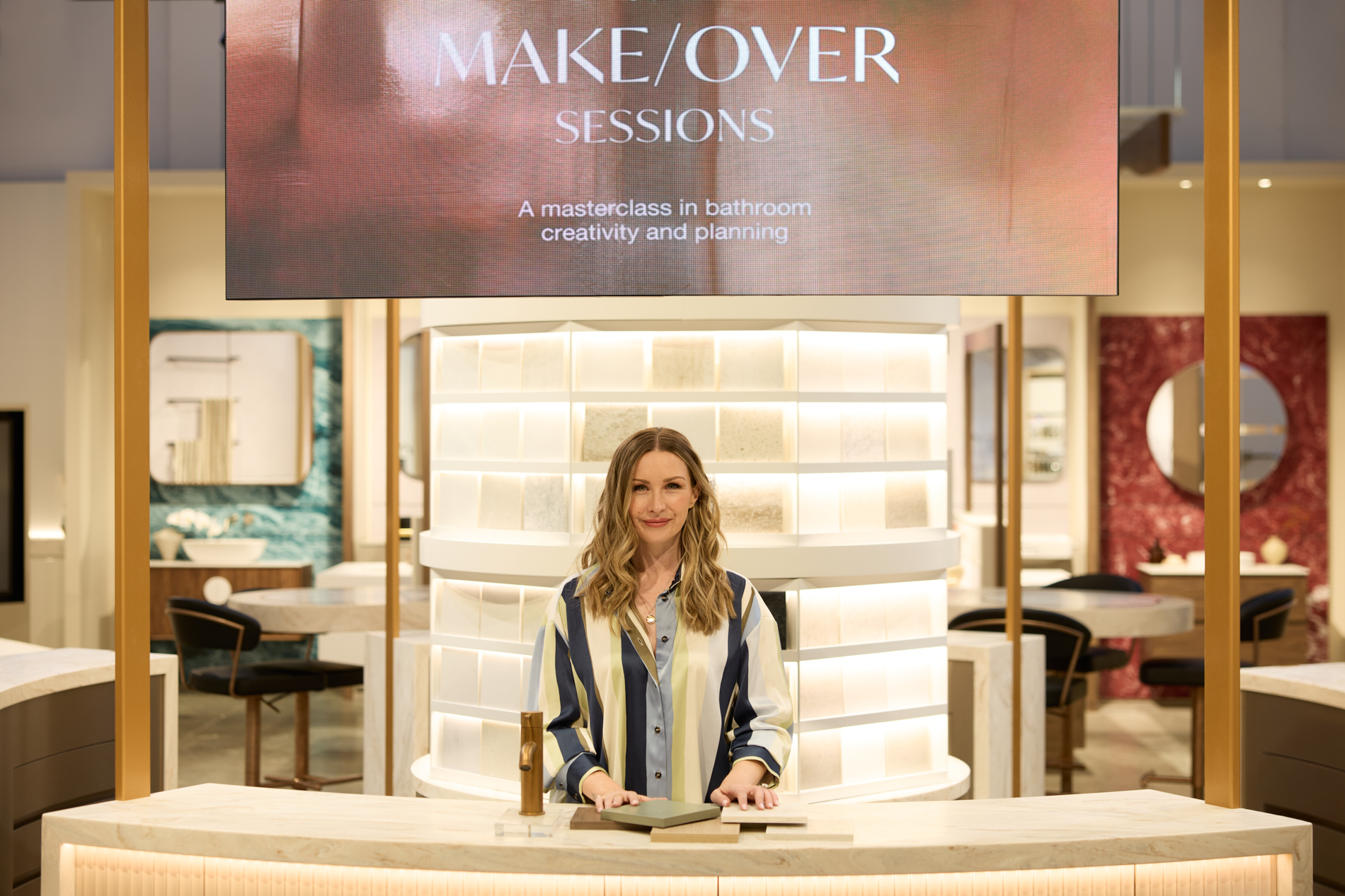 Keri-Ann Jones stands below a screen demonstrating what one of our makeover sessions.