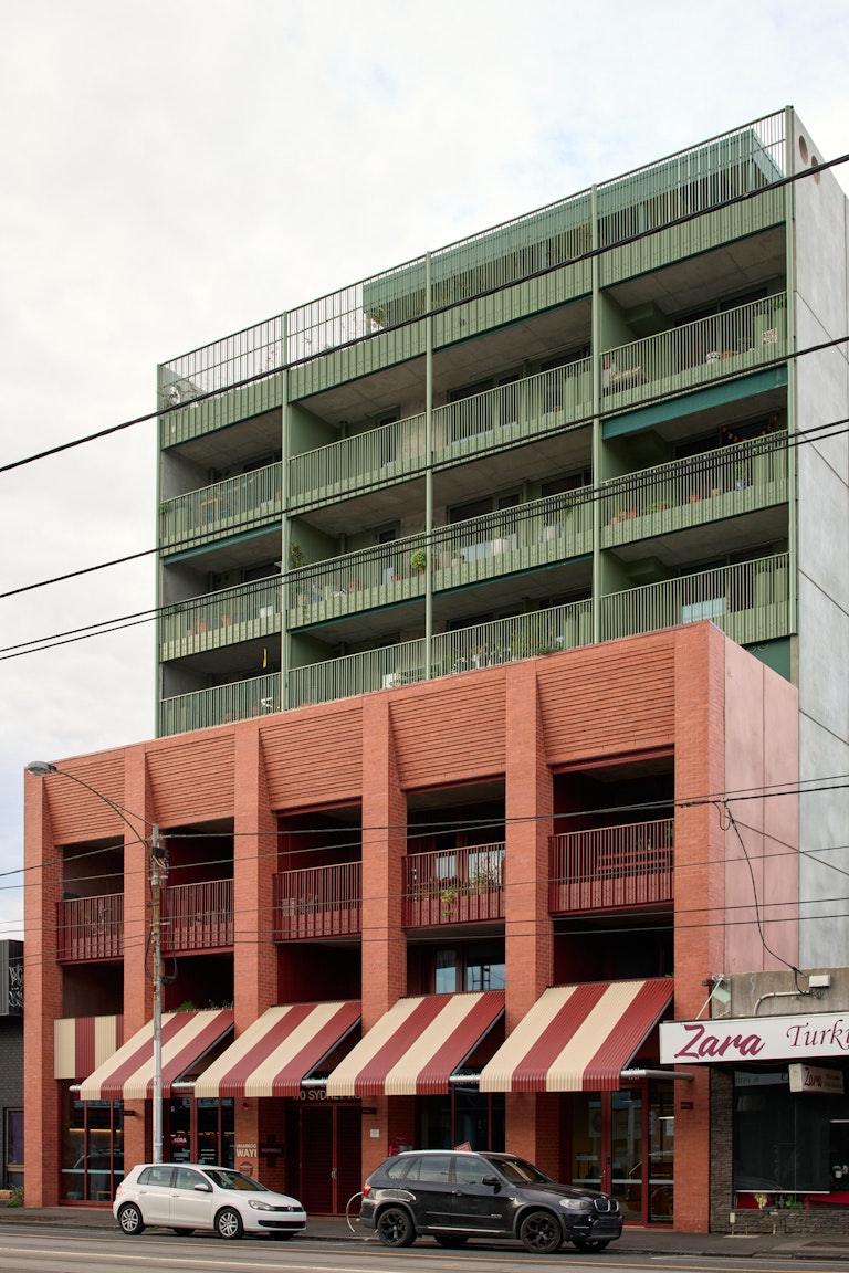 Front of building - Two cars with a brick facade