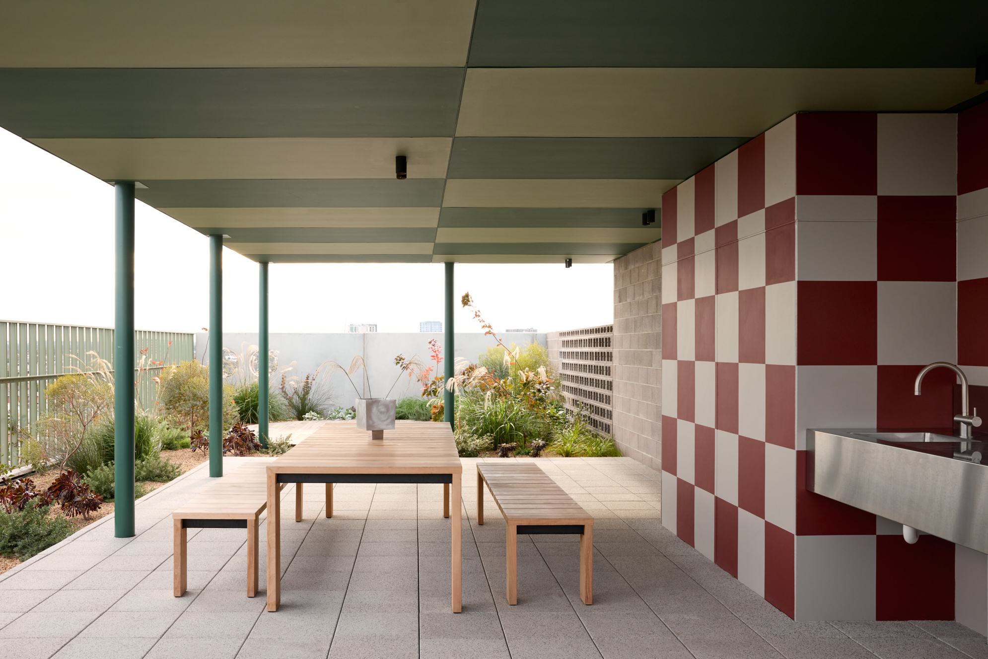 Shared BBQ space on top of building - Picture shows sheltered shared seating space, garden, sink and tapware