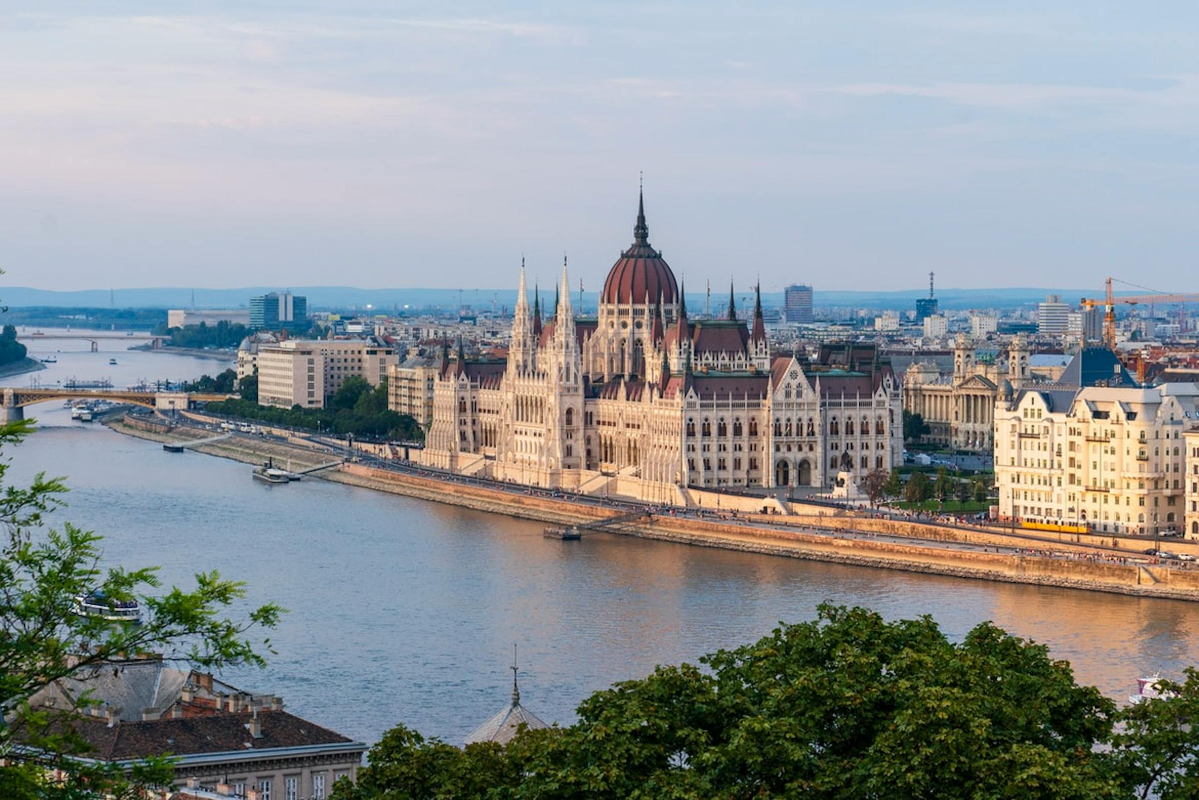 Hungary's Parliament Building glows at dusk beside the Danube River in Budapest.