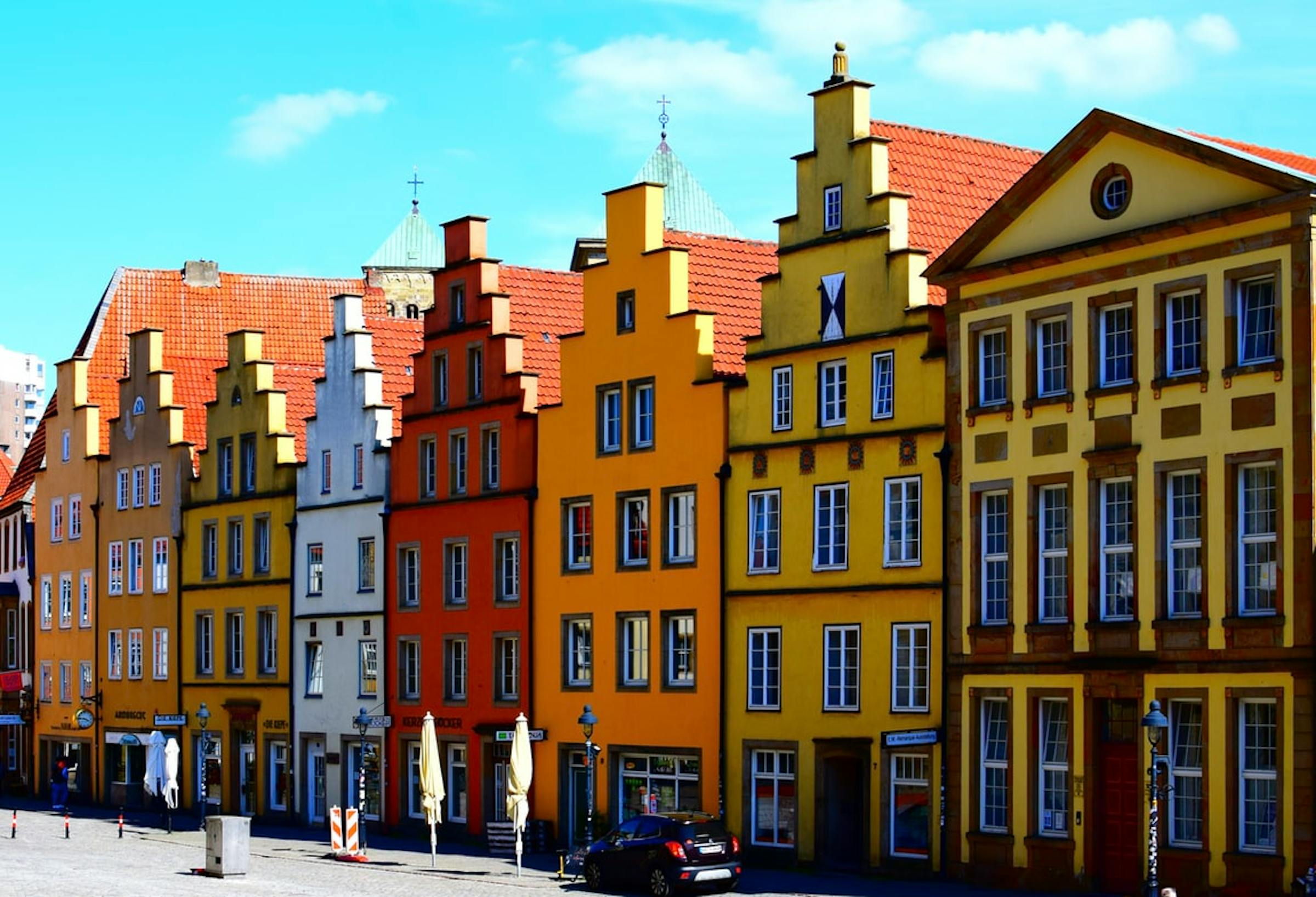 Colourful stepped-gable townhouses line a cobbled square in Osnabrück's reconstructed old town.