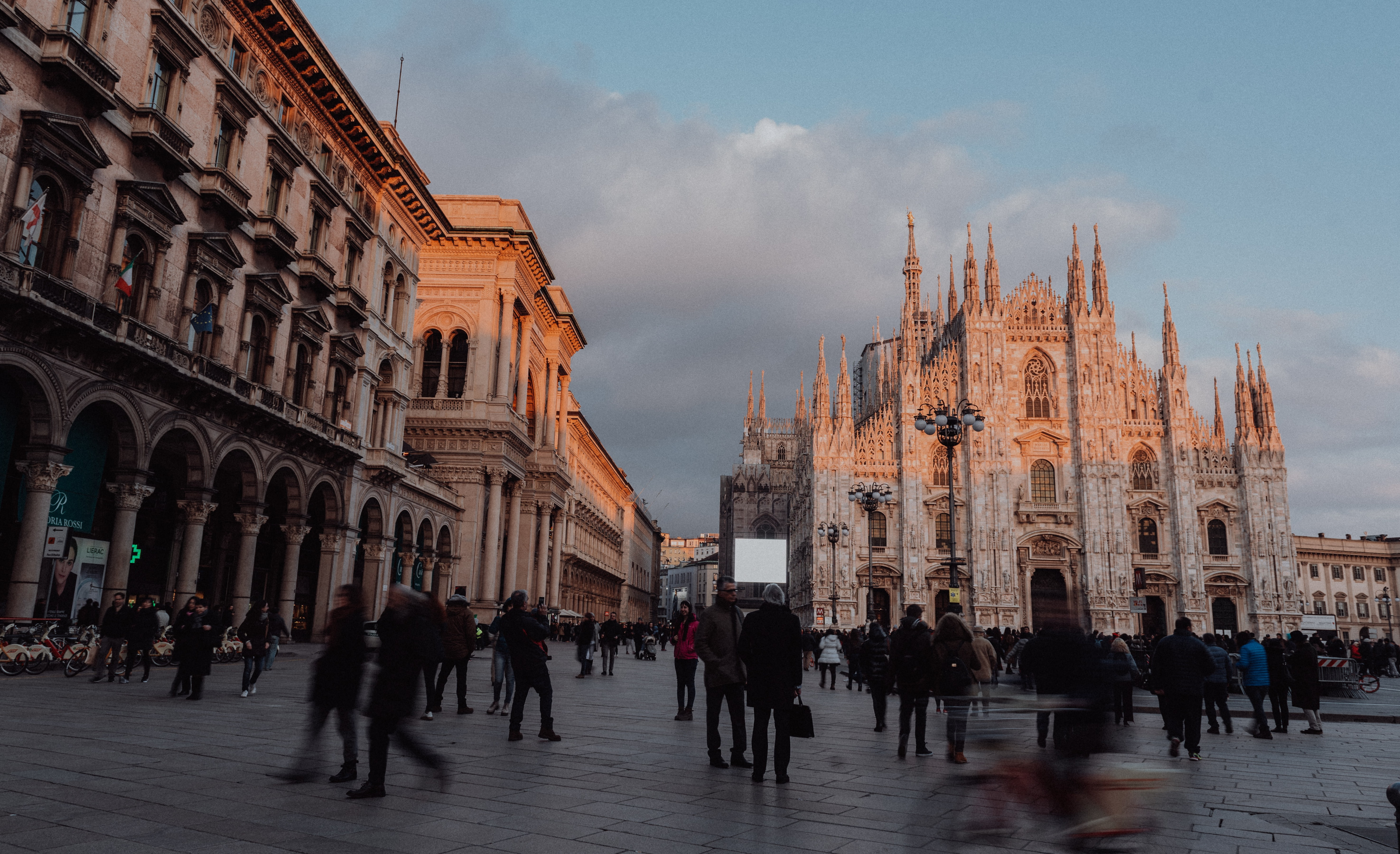 The sunset lingers over the Duomo di Milano, the second largest