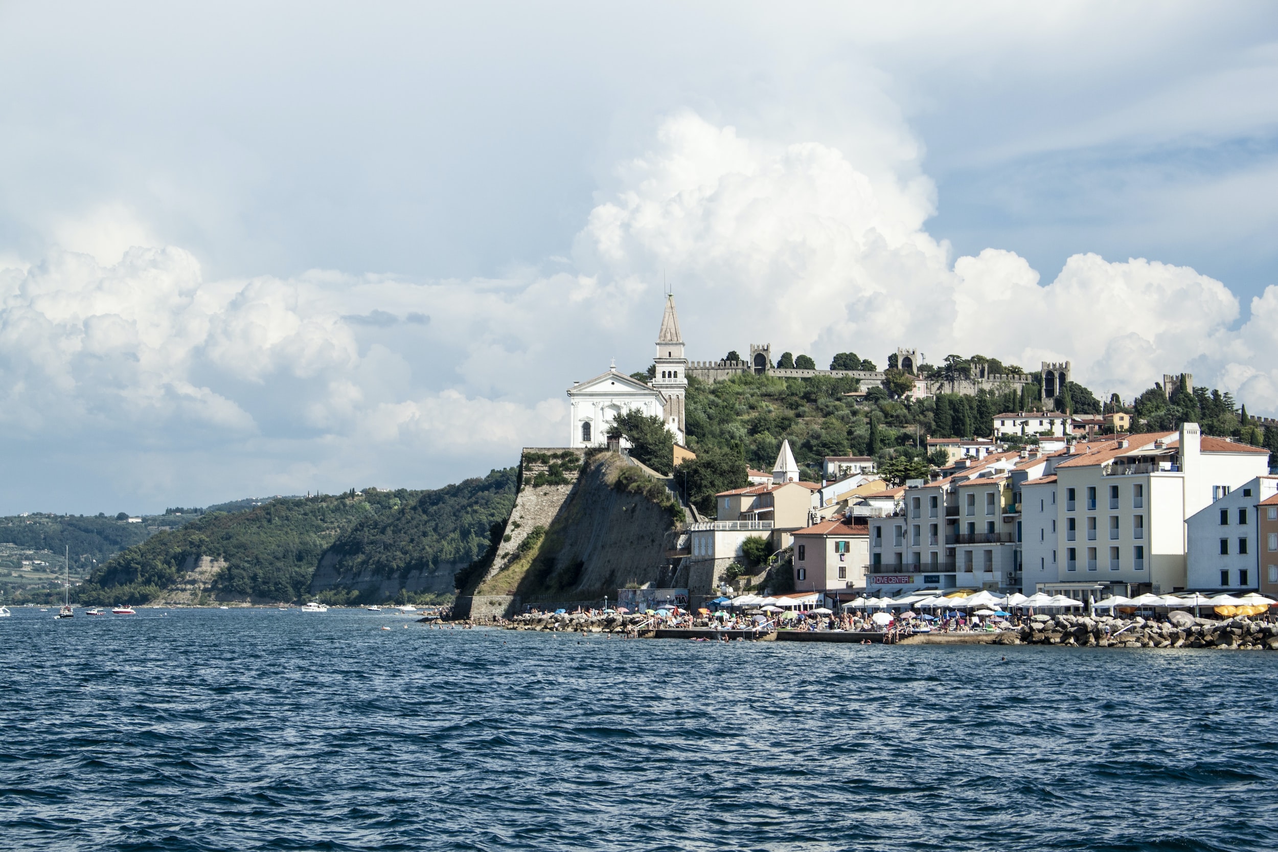 white concrete buildings beside sea during daytime