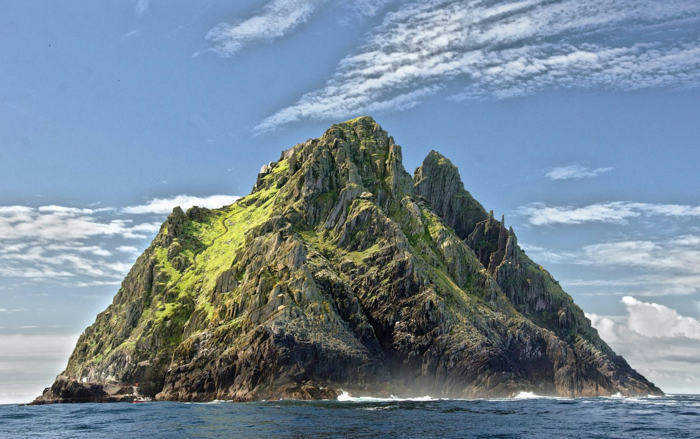 Skellig Michael's steep, moss-covered cliffs rising from the Atlantic off Ireland's south-west coast.