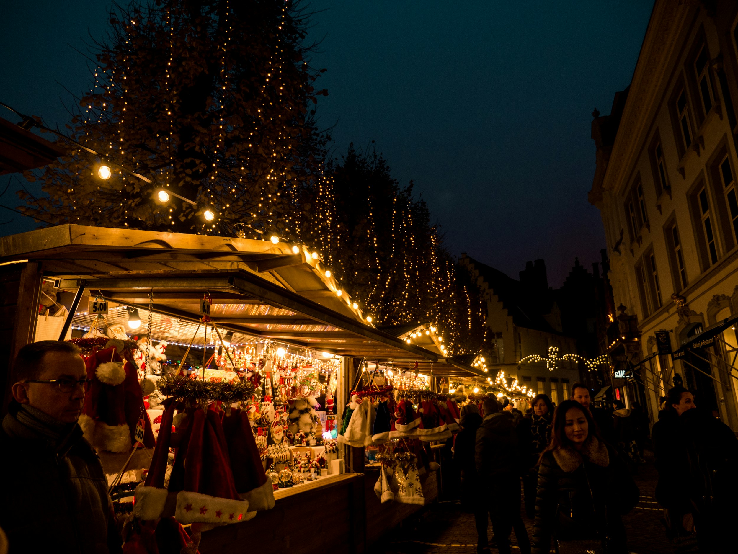 people walking on street with Christmas decor store