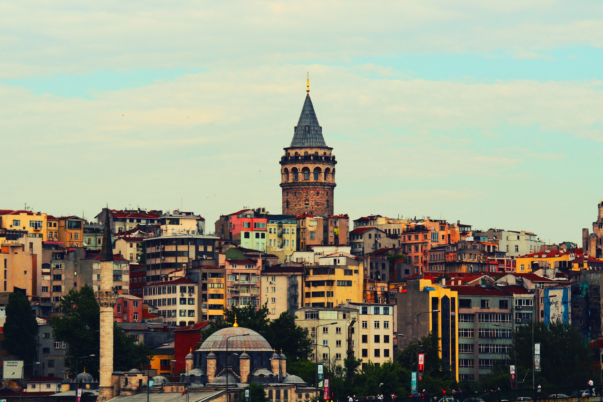 a view of the city of istanbul, with colourful buildings and a spire