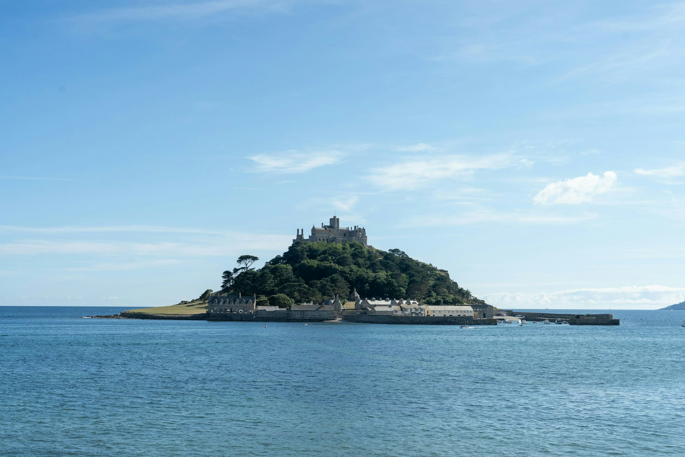 St Michael's Mount rises from the sea, its castle and trees crowning the Cornish tidal island.