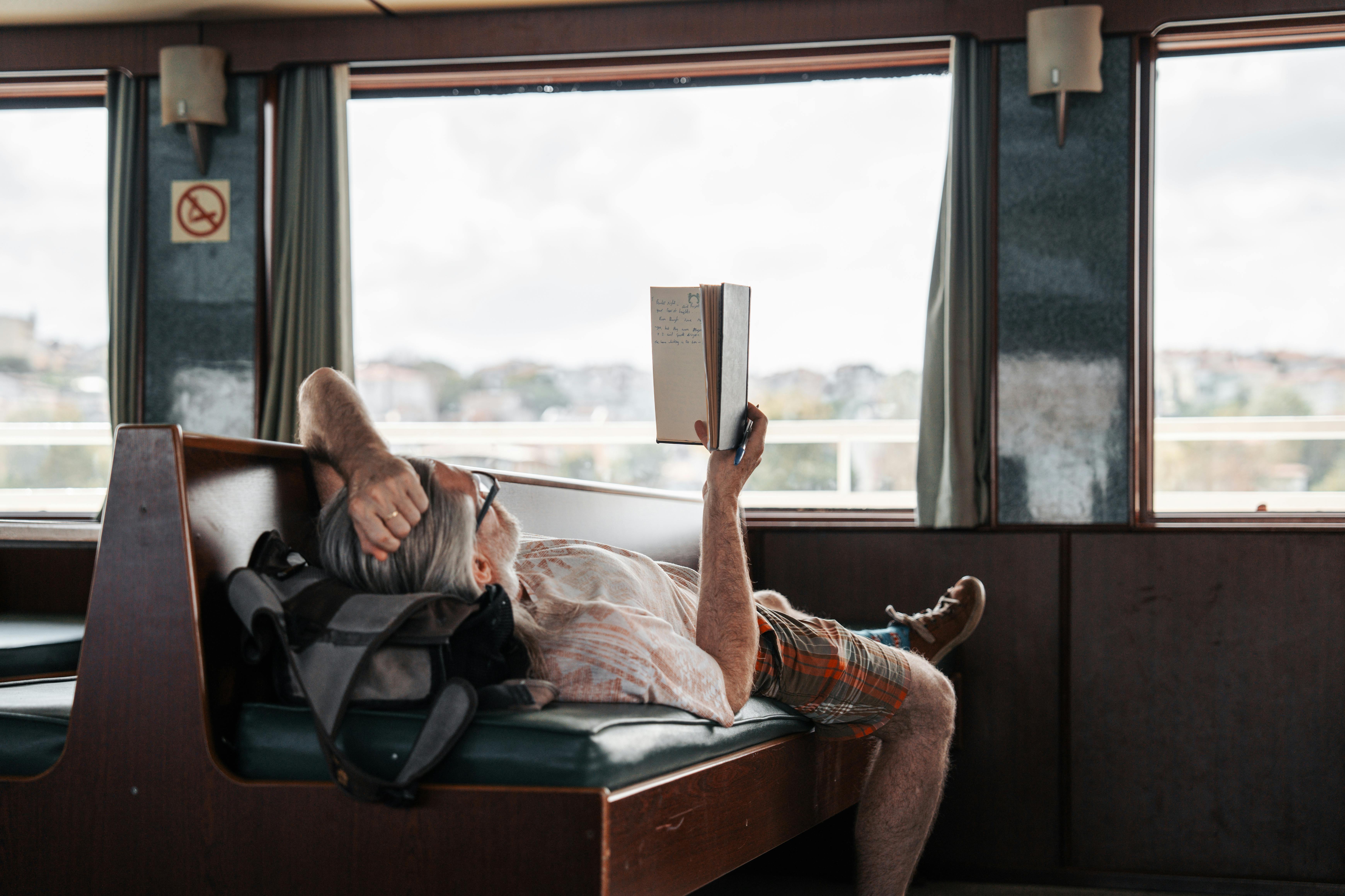 Man relaxing reading book