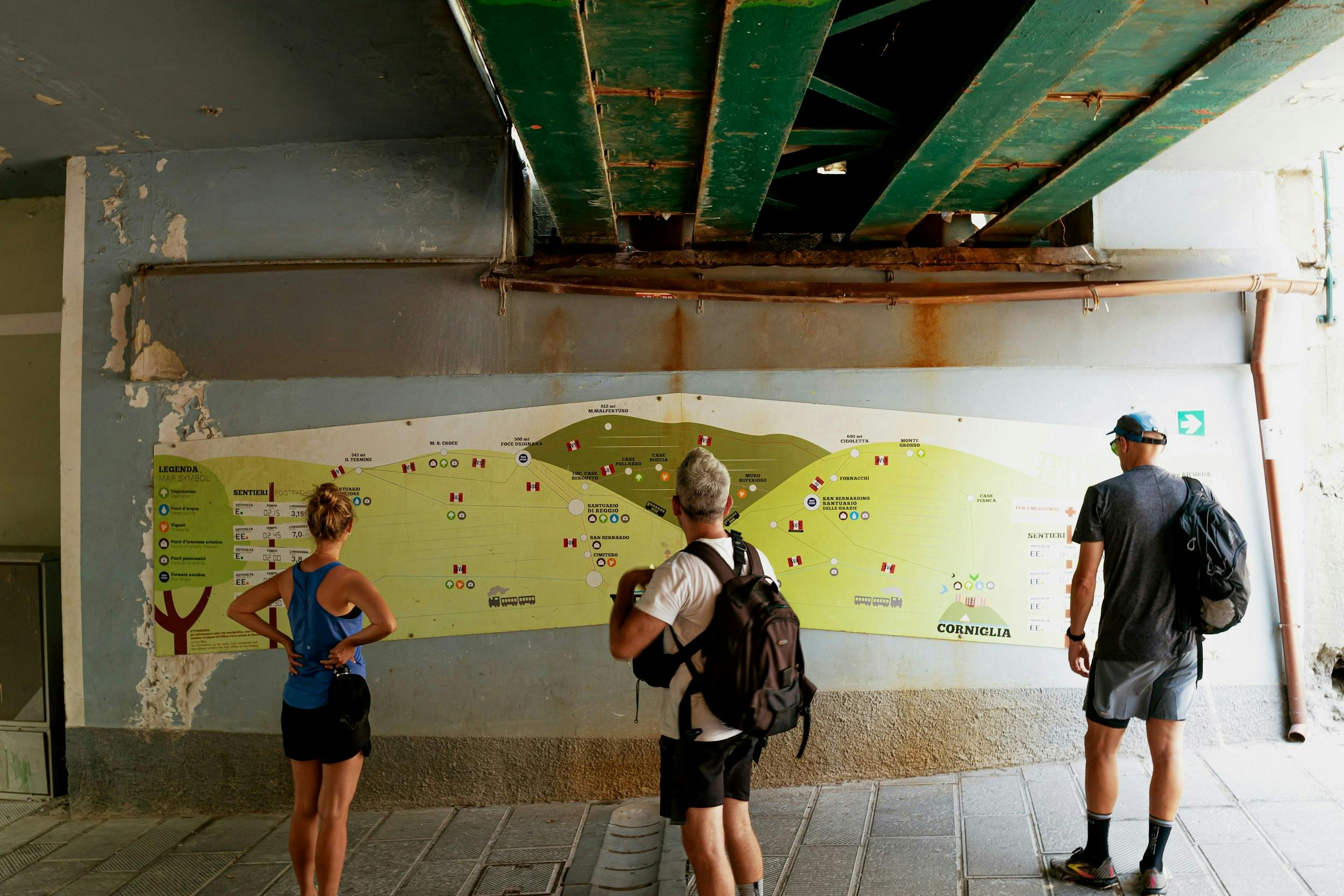 A group of people standing in front of a map