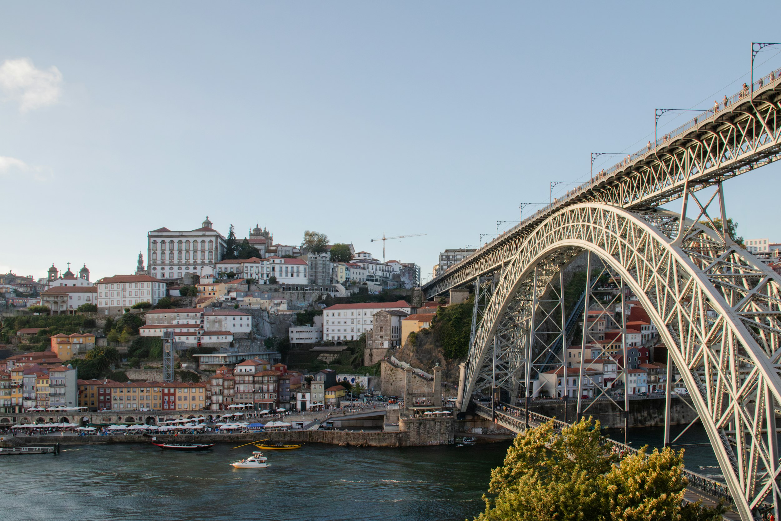 A bridge over a river with a city in the background