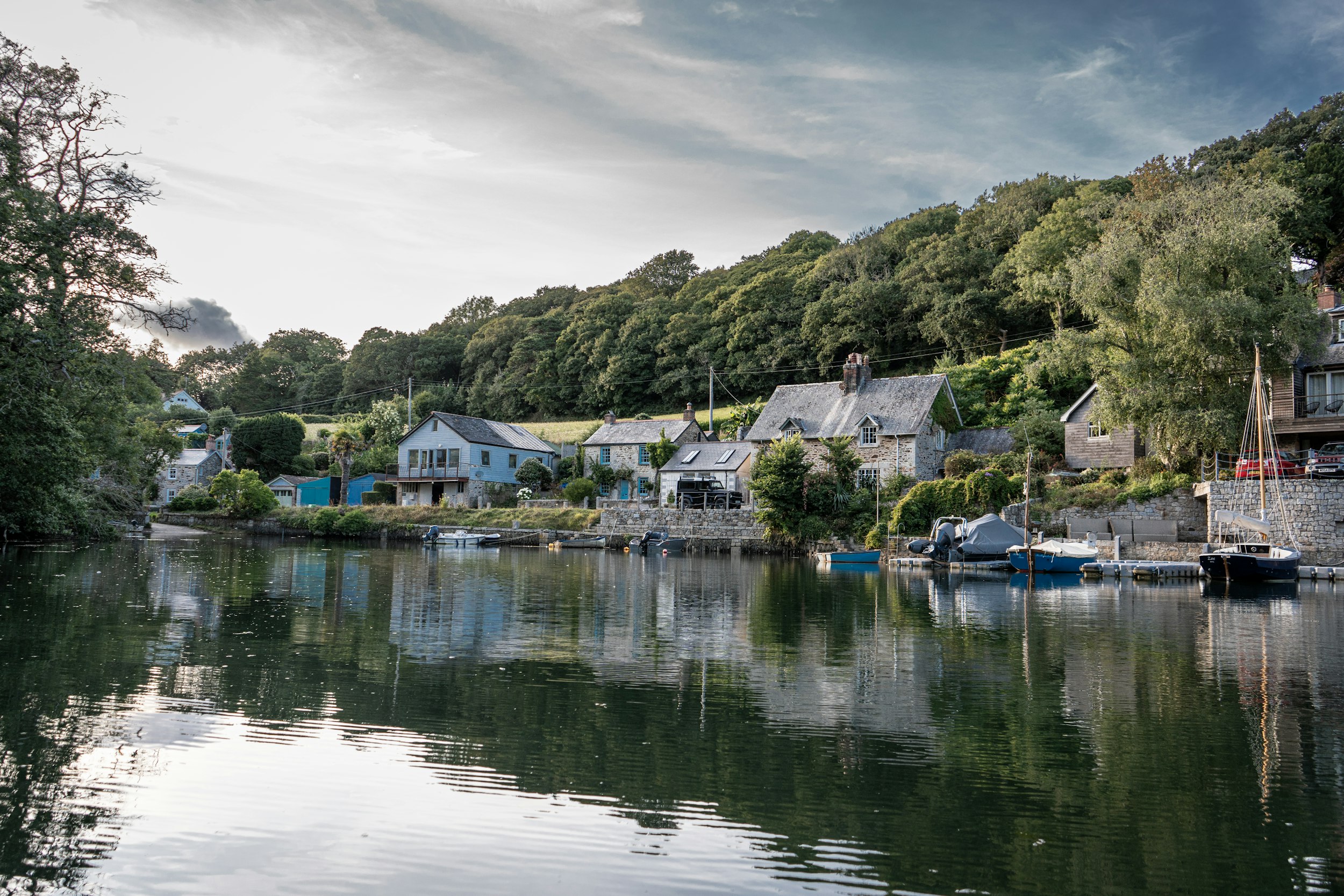a body of water surrounded by trees and houses