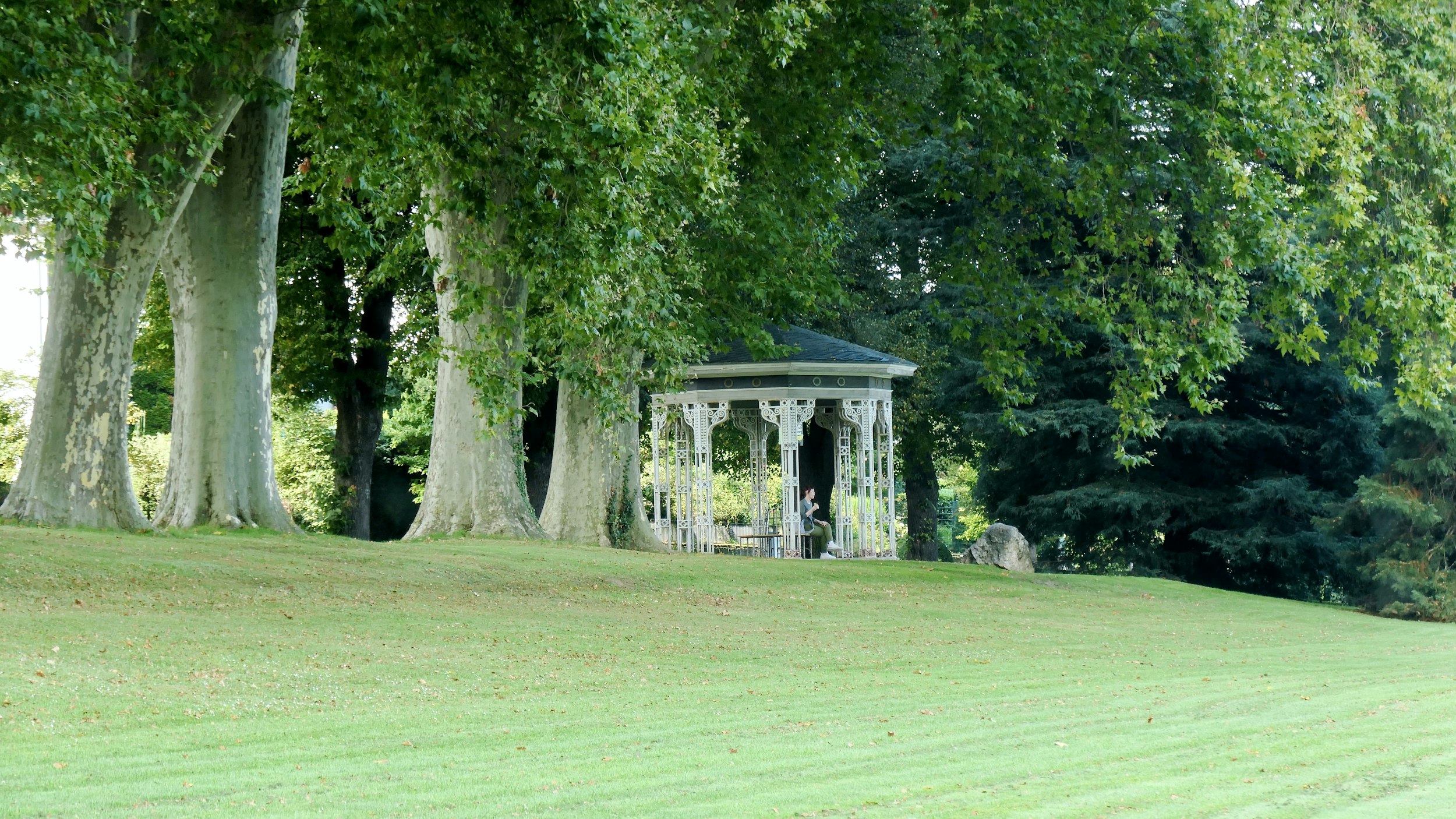 a gazebo in the middle of a grassy field