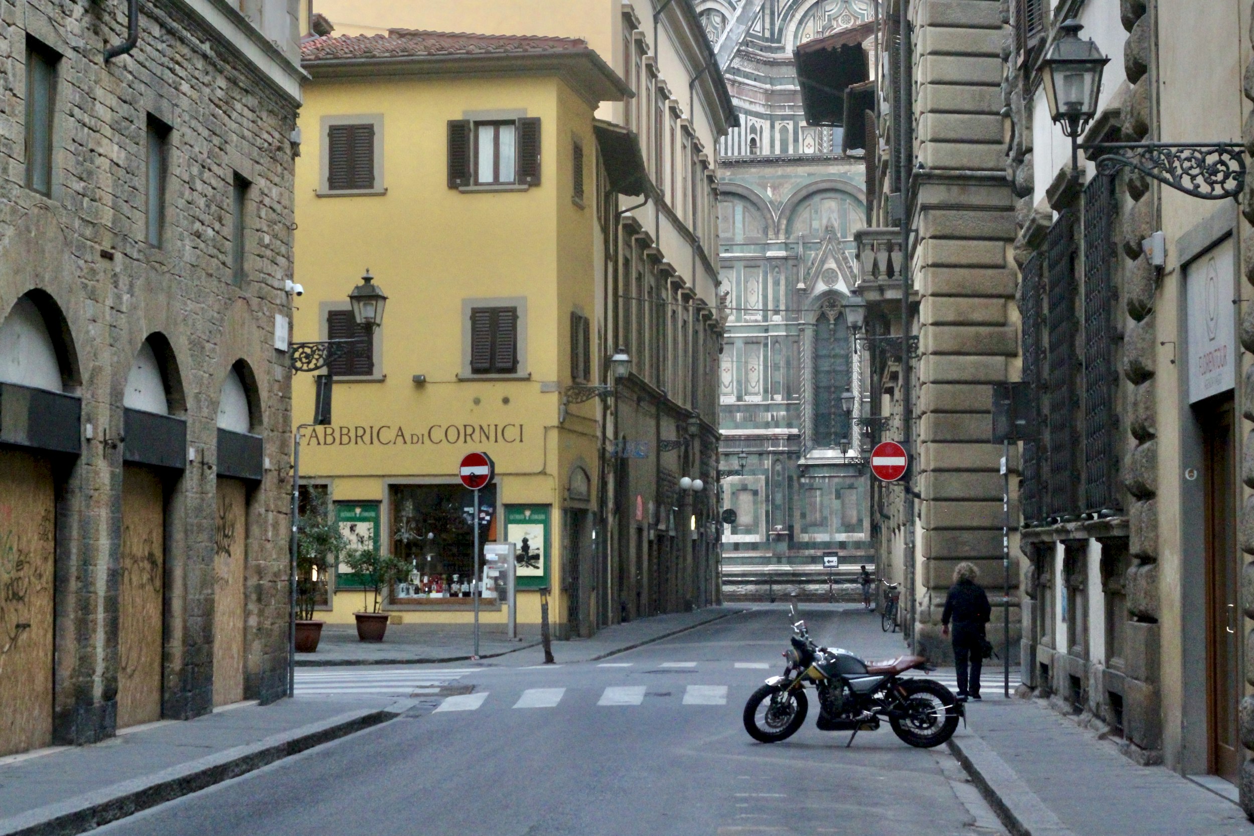 black motorcycle parked near pedestrian crossing