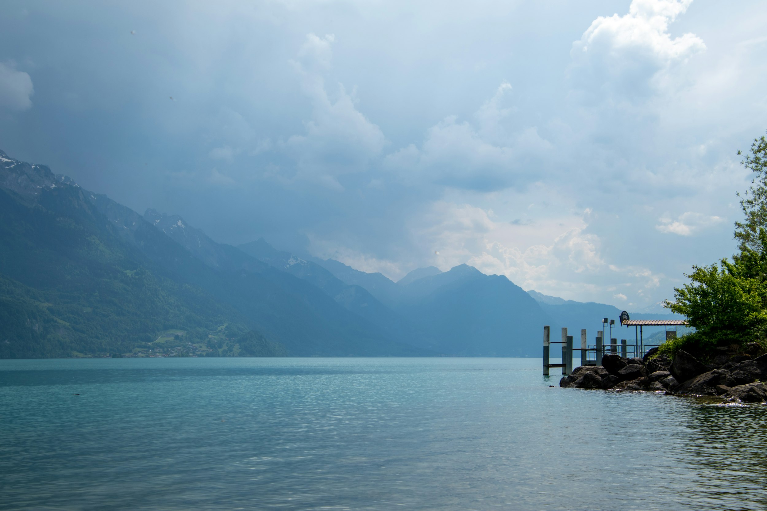 a body of water with mountains in the background