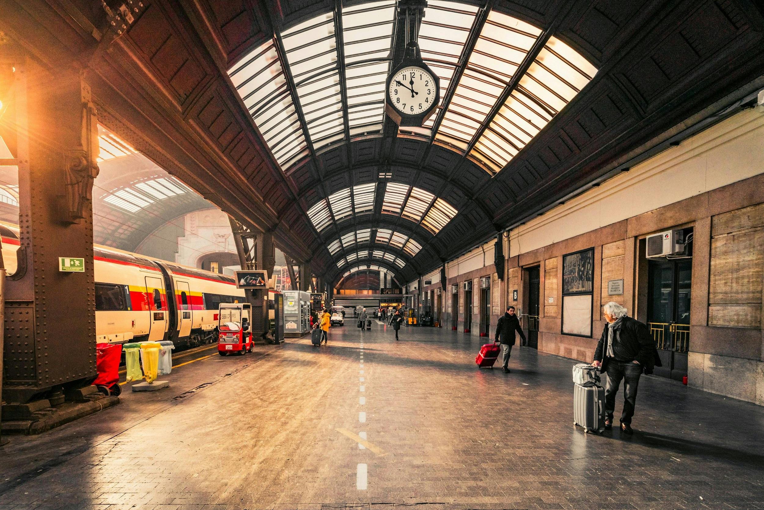 a train station with people and luggage