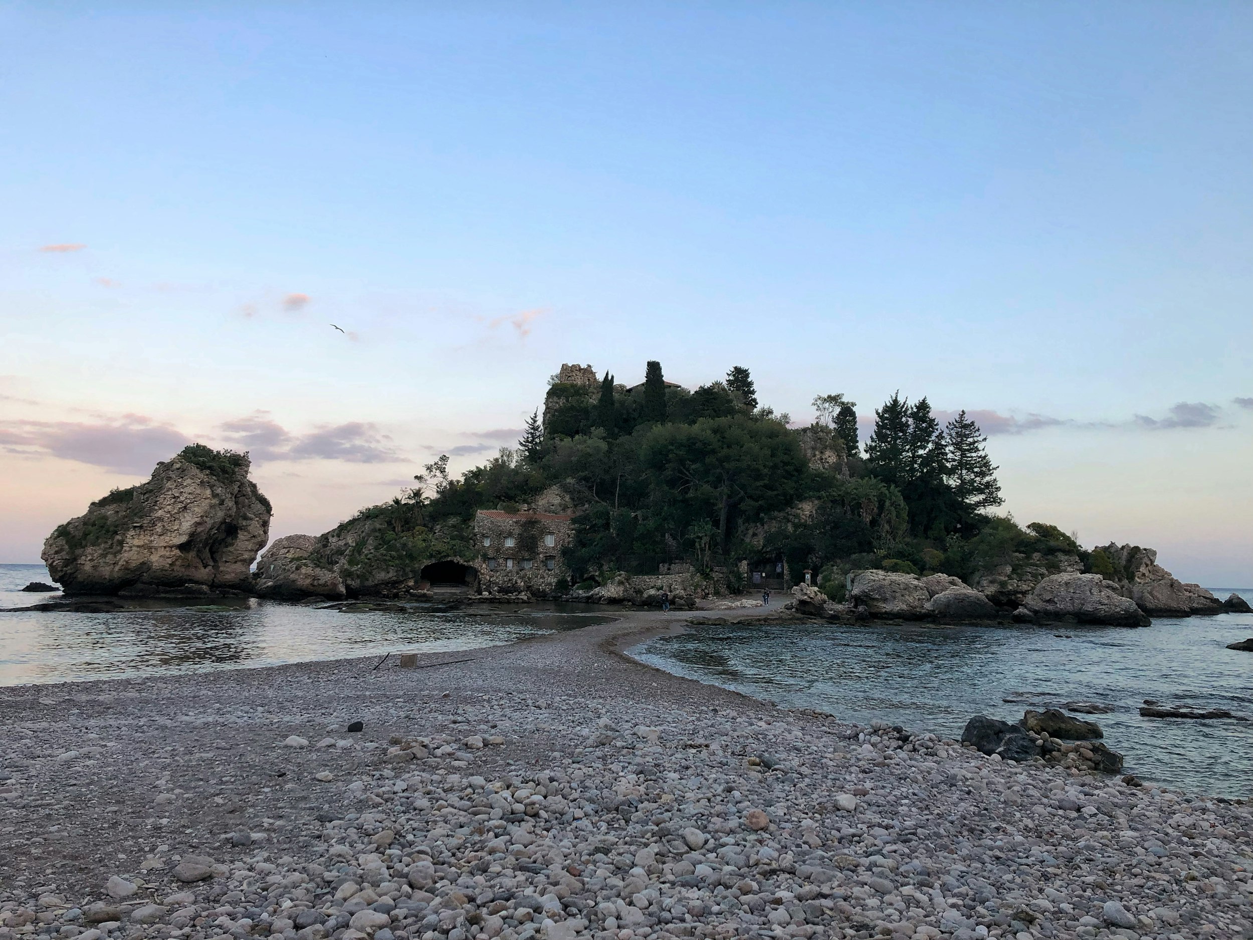 rock formation near calm body of sea