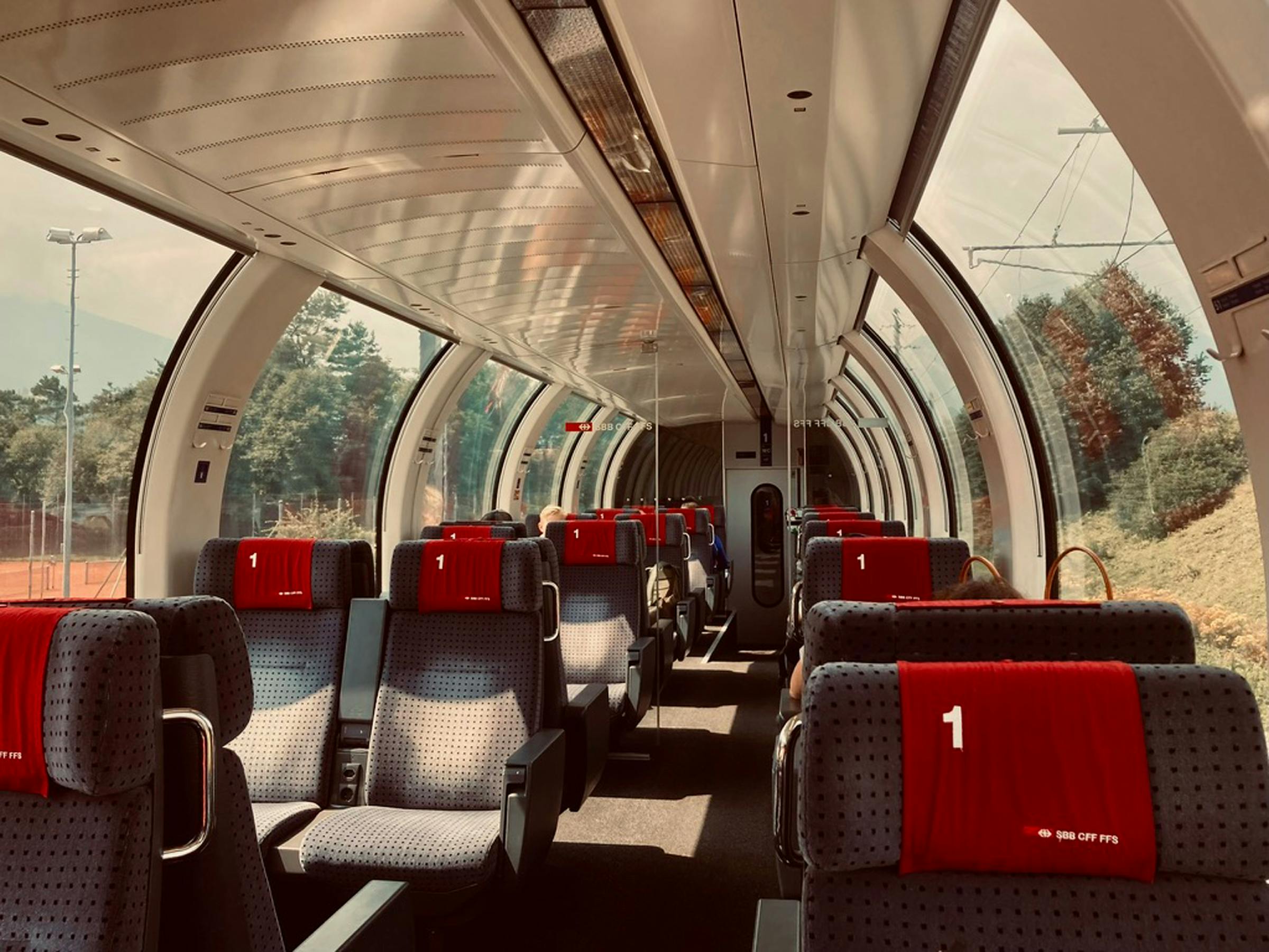 Panoramic first class carriage on a Swiss SBB train with red '1' headrest covers