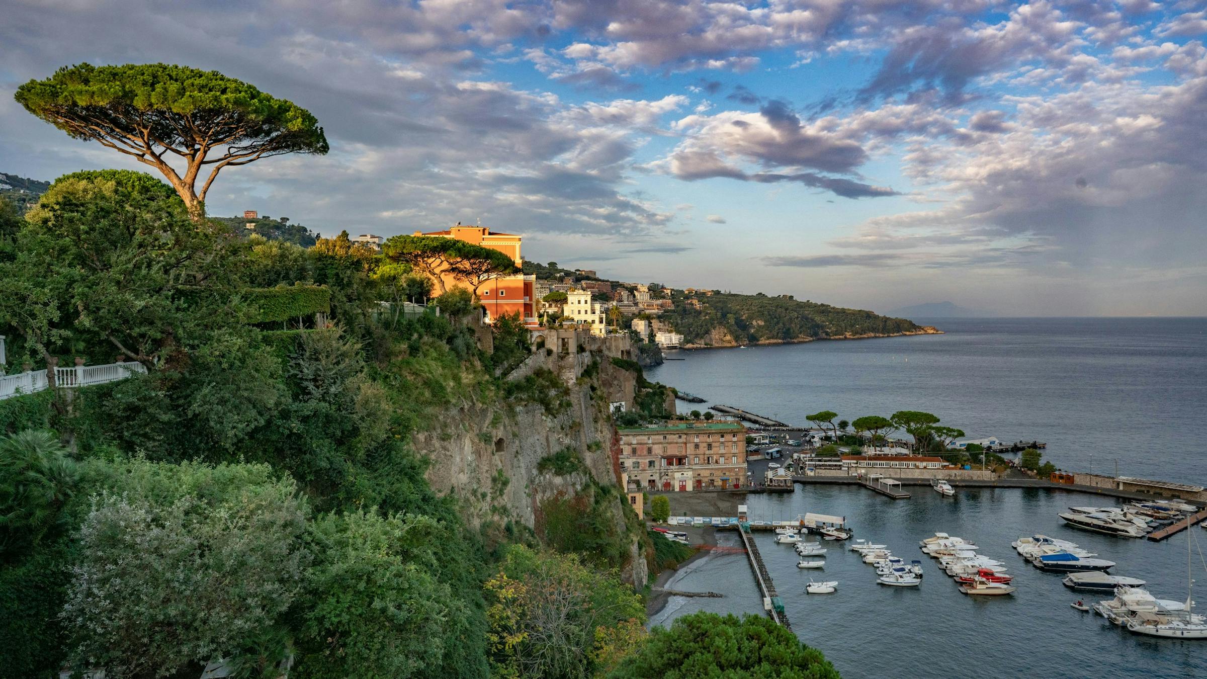 a scenic view of a harbor with boats in the water