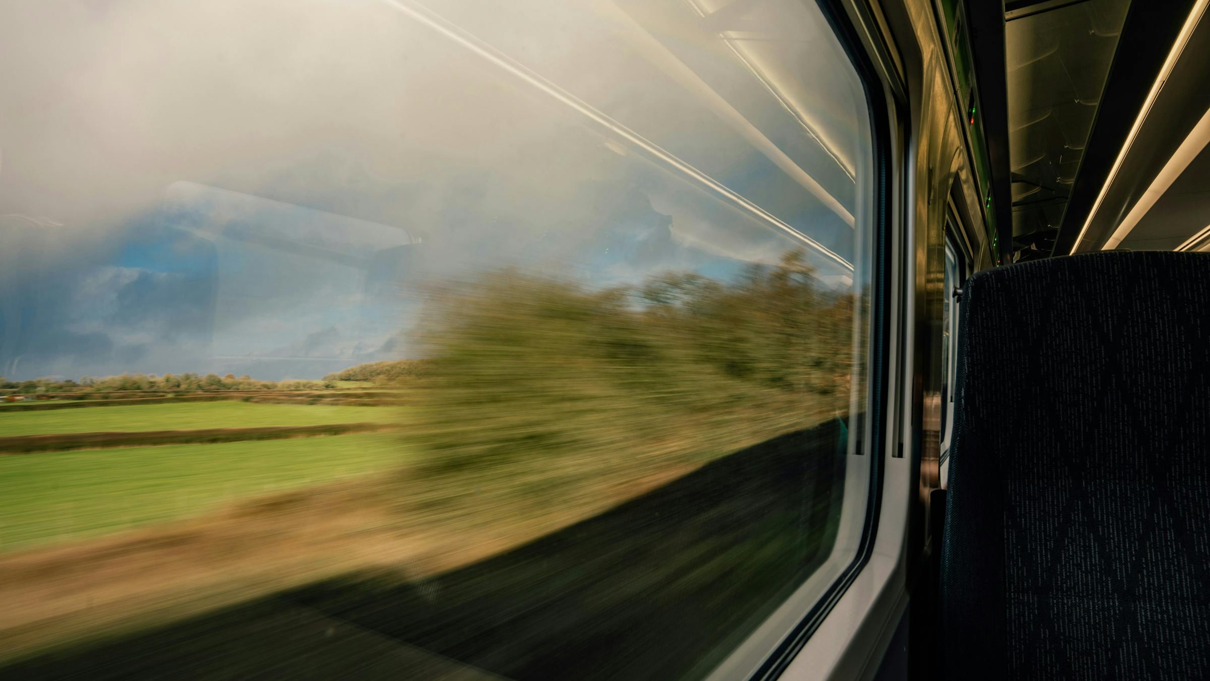 green fields whizzing past from train window