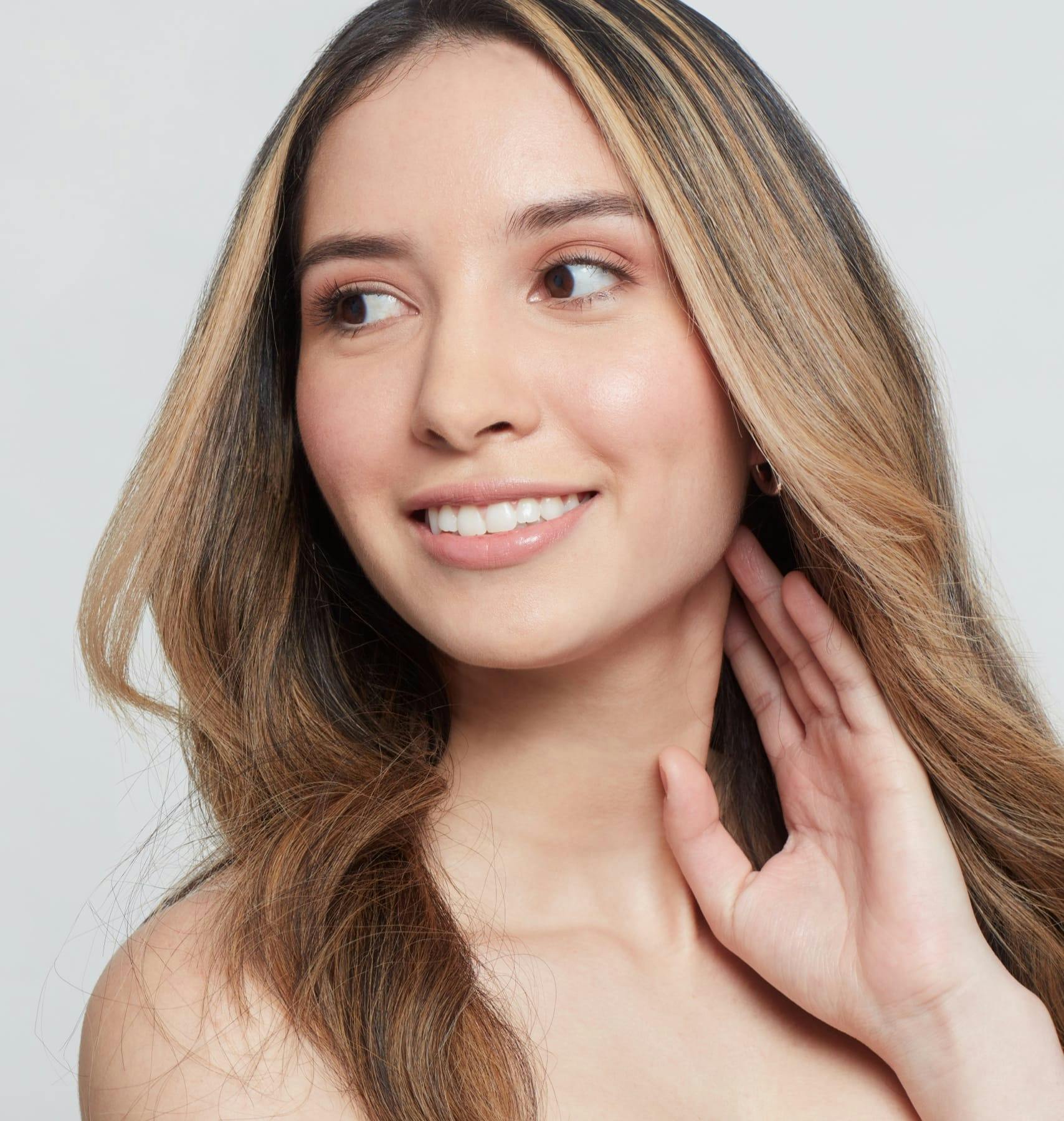 Woman smiling, looking to the side