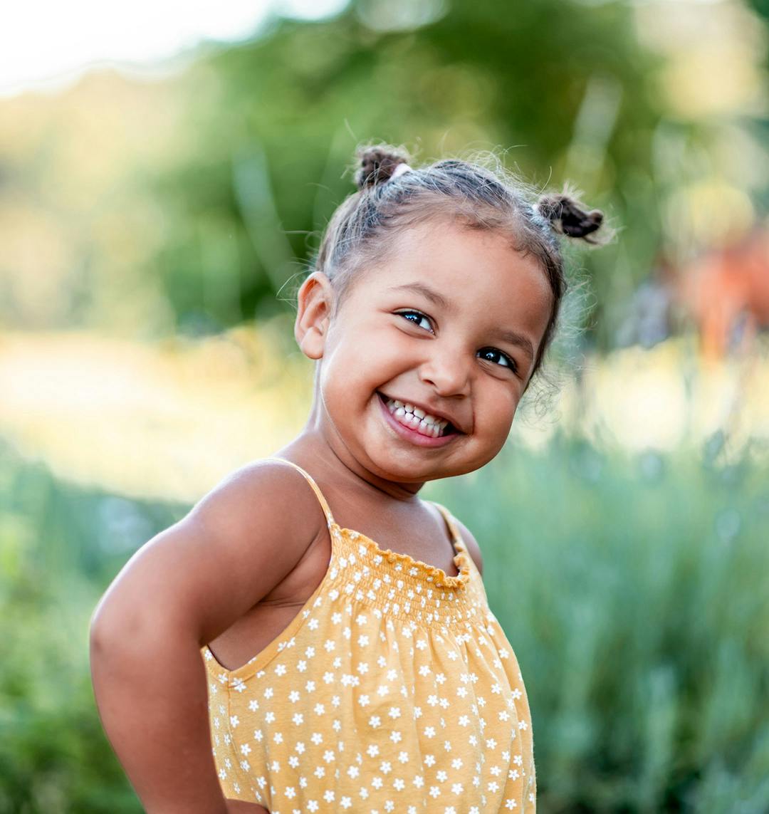 Young girl outside in a yellow top