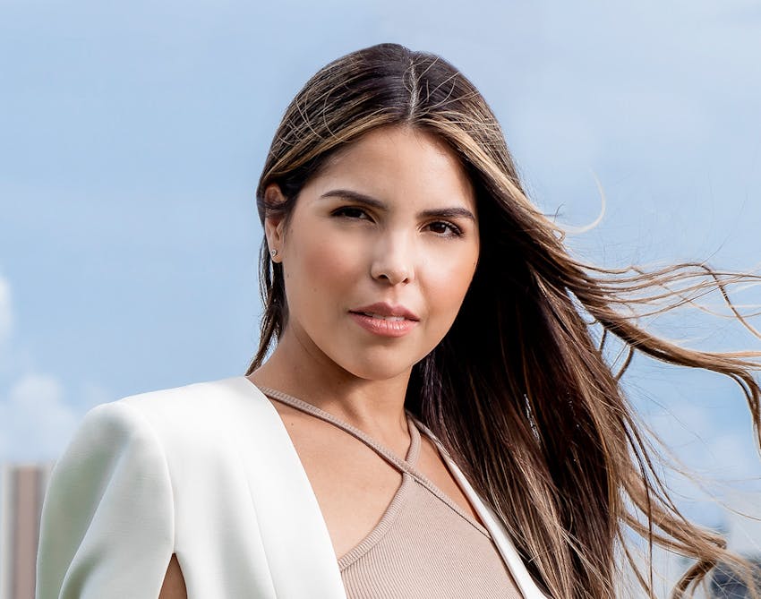 Woman standing outside with her hair blowing in the wind