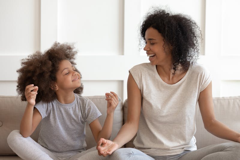 a woman and a child sitting on a couch