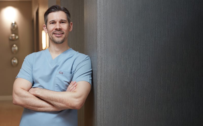 Miami Plastic Surgeon, Dr. Joshua Lampert, standing with his arms crossed