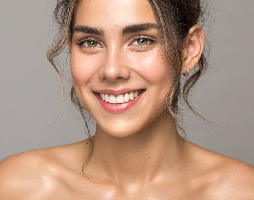 Beautiful woman with clear skin and her hair tied up