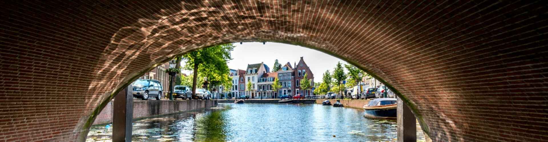 A view out from underneath a bridge on a Dutch canal