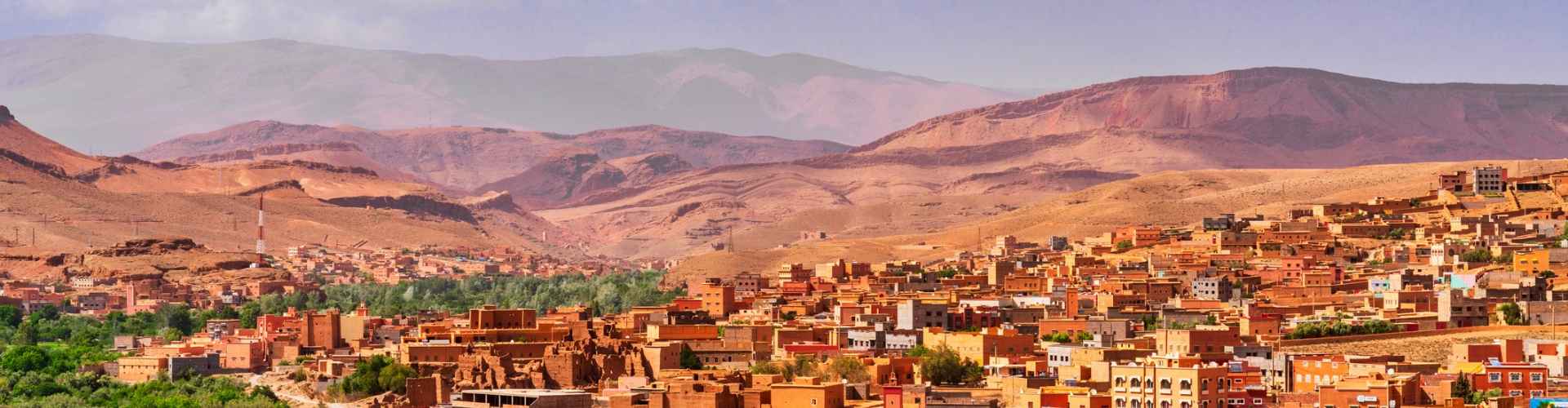 A desert town in Morocco with the Atlas Mountains in the background