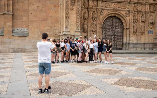 Teacher taking photograph of students