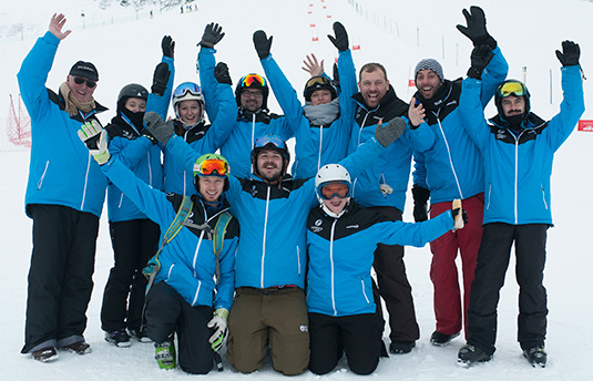 The Halsbury Travel Ski Team Group of ski professionals waving