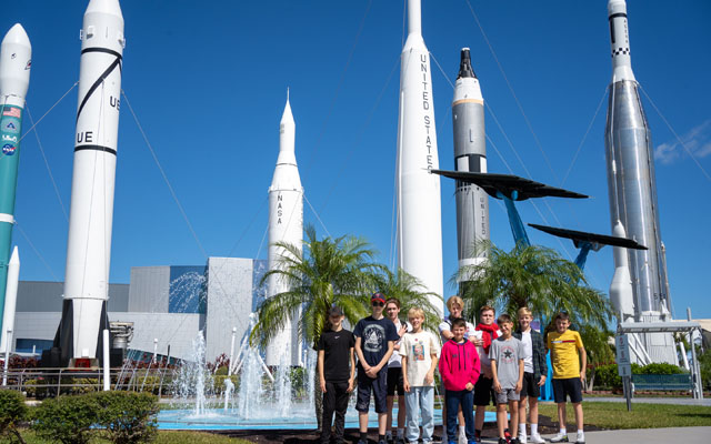 Students standing in front of rockets