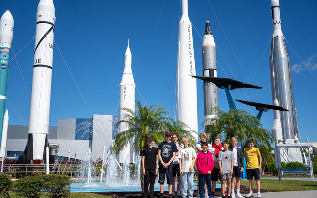 Students standing in front of rockets Students standing in front of rockets