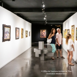 Visitors looking at works of art in MIAM