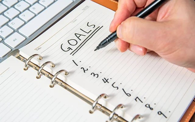 A lined notebook with a numbered list of goals