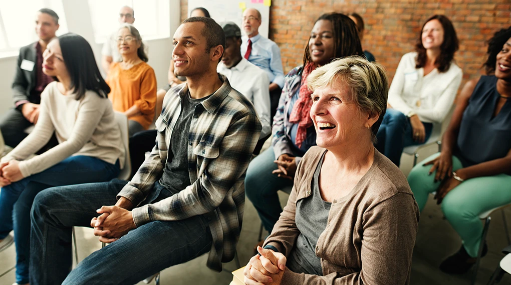 Group of adults smiling at a parents evening