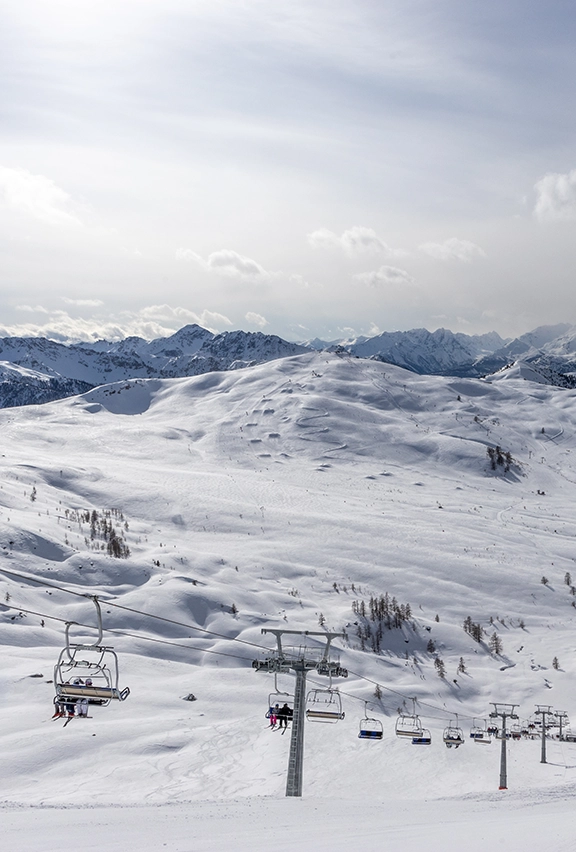 Chair lifts carrying skiiers up a mountain
