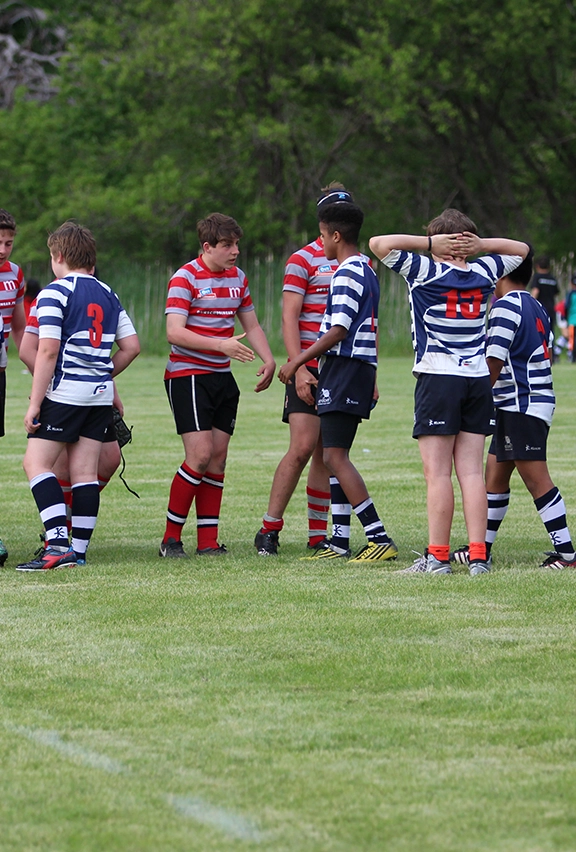 Two school rugby teams shaking hands